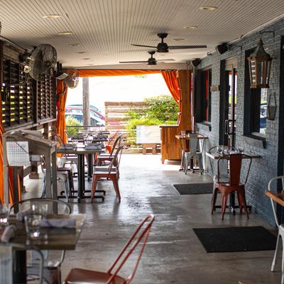 Covered patio, tables and chairs.