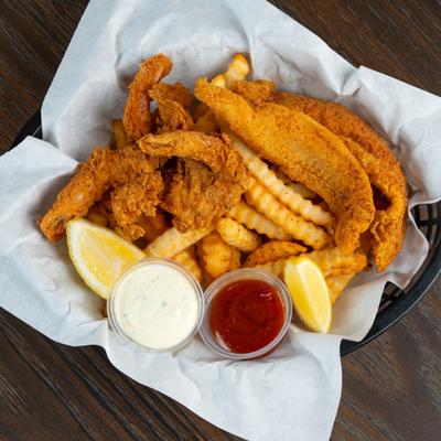 Fried fish and shrimp served with fries, dipping sauces and lemon wedges.