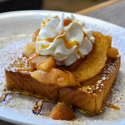 French toast with apple slices and whipped cream.