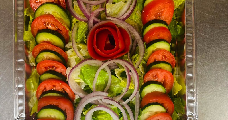 Salad with lettuce, onion, tomato, and cucumber