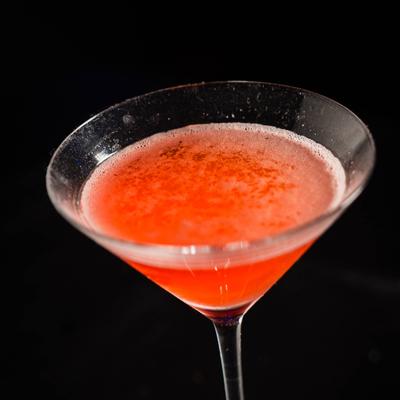 Bright red cocktail in a martini glass.