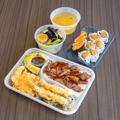 Beef teriyaki Bento Box, with maki rolls, spring roll, shrimp, and vegetable tempura.