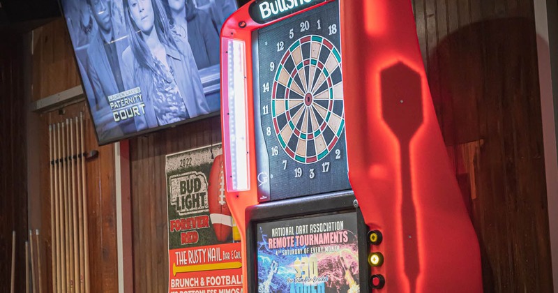 Interior, dart board, big TV screen on the wall