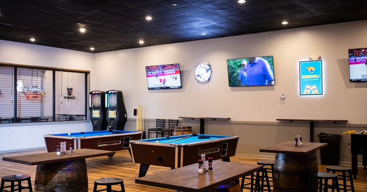 Interior, seating area, pool tables and dart boards, TV screens on the wall