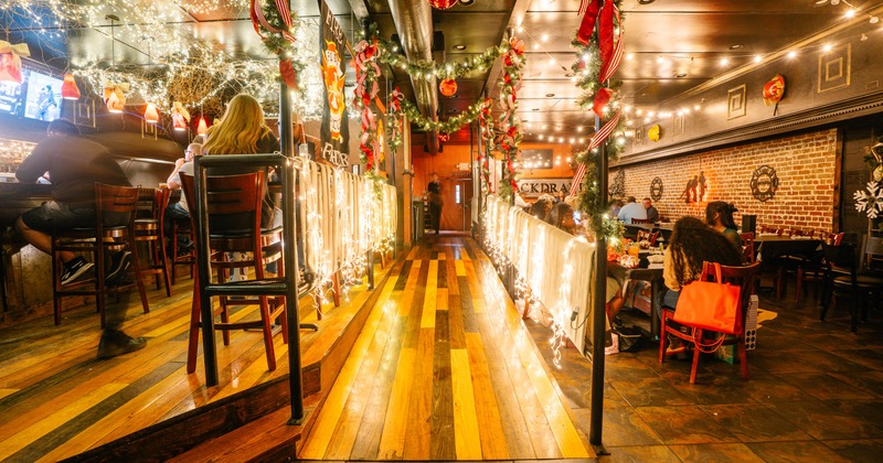 Festively decorated restaurant with warm lighting, garlands, and ornaments