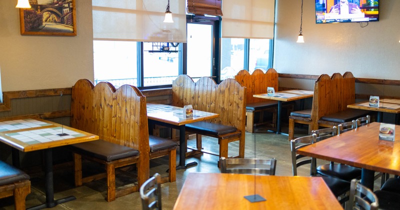 Interior, dining area, restaurant entrance, wooden seating booths with tables