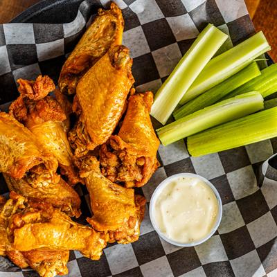 Wings with celery and a sauce.