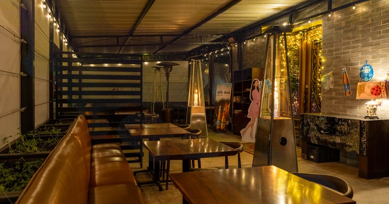 Exterior, patio, covered seating area, banquette benches with tables, space heaters