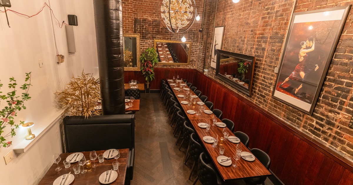 Long dining room with brick walls and hanging lights