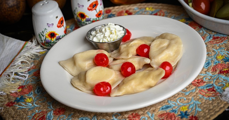 Stuffed dumplings with cherries and whipped cream