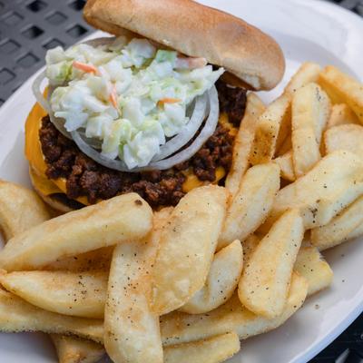 Carolina Burger topped with fresh onion adn coleslaw, served with fries.