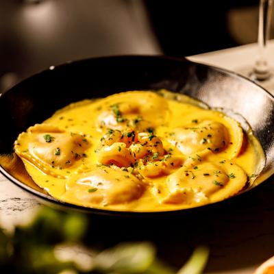 Lobster ravioli in lobster cream sauce, topped with chopped shrimps.
