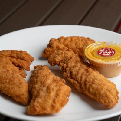 Chicken Tenders served with a side of dipping sauce.