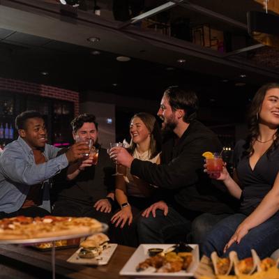 Adults having a fun time while eating and drinking..