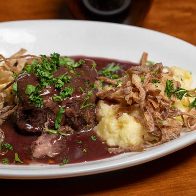Beef short rib, served with banana polenta, frizzled onion, and topped with a red wine sauce.