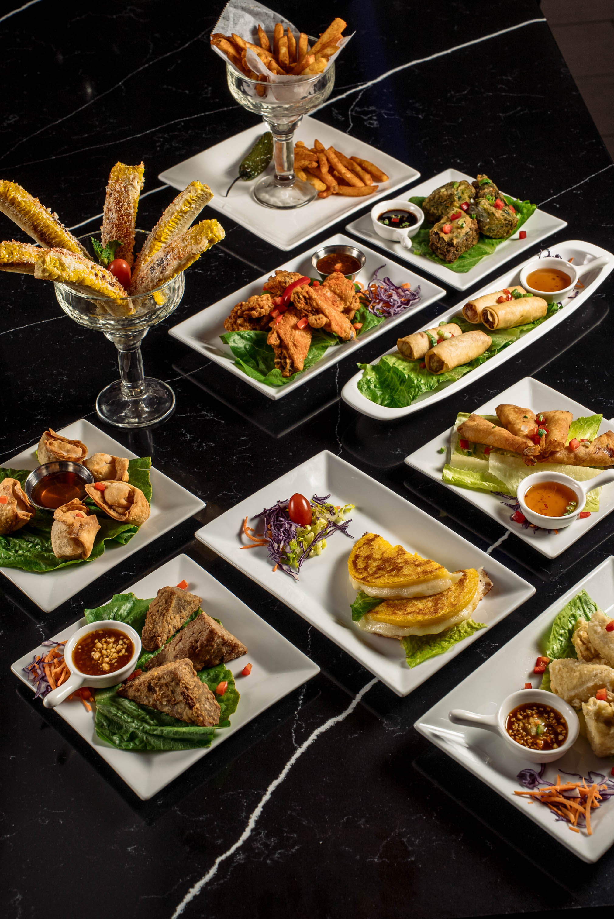 Assorted dishes spread across a black table