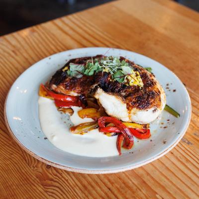 Grilled Half Chicken with pepper - mushroom ragout, potatoes, and lemon aioli.