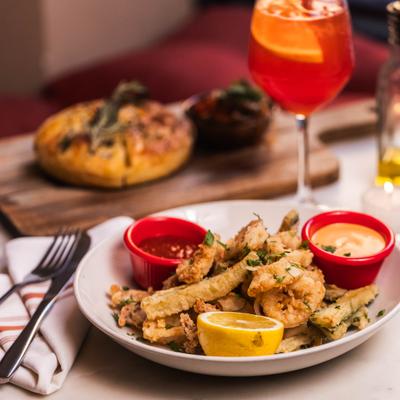 Fried calamari with dipping sauces and Aperol spritz.
