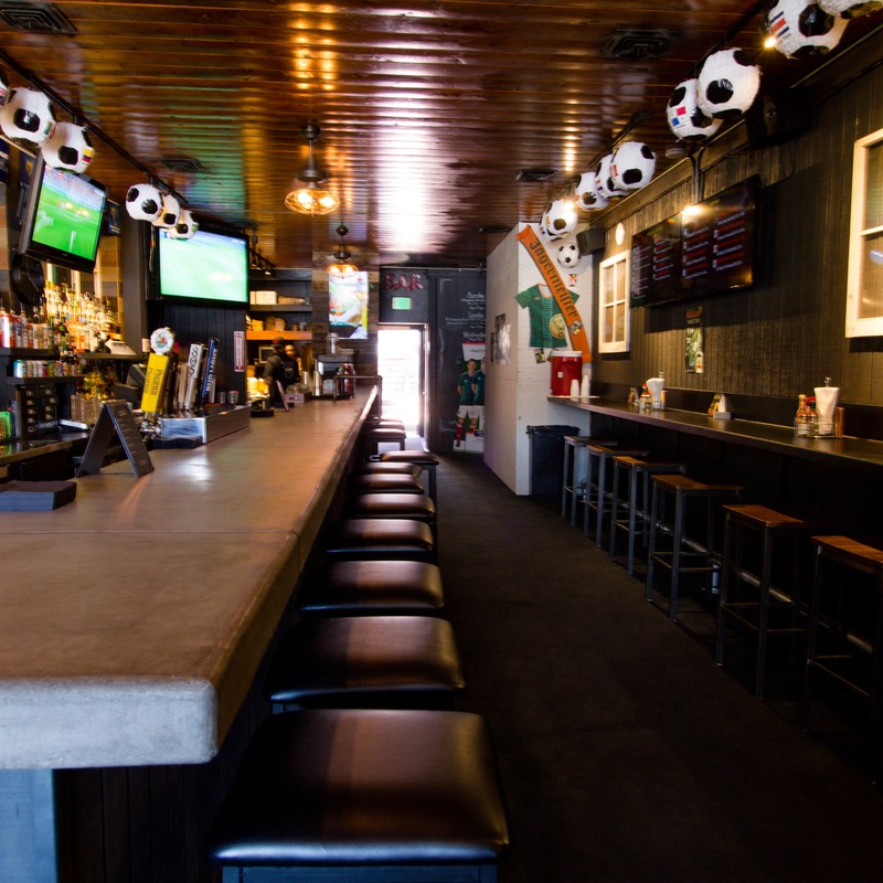 Interior, bar seating area, a row of barstools