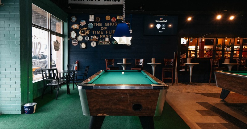 Interior seating area with chairs, tables and pool tables
