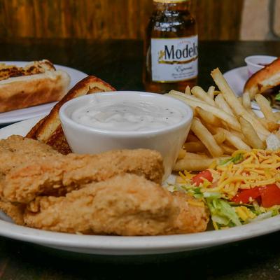Fried chicken tenders with fries, salad, toast, and dipping sauce.