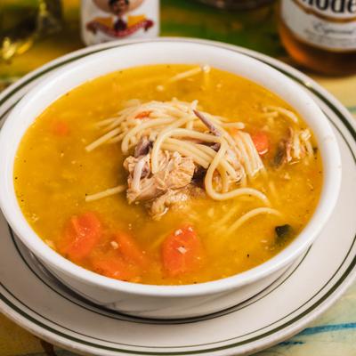 Bowl od Chicken soup with noodles and vegetables, close-up.