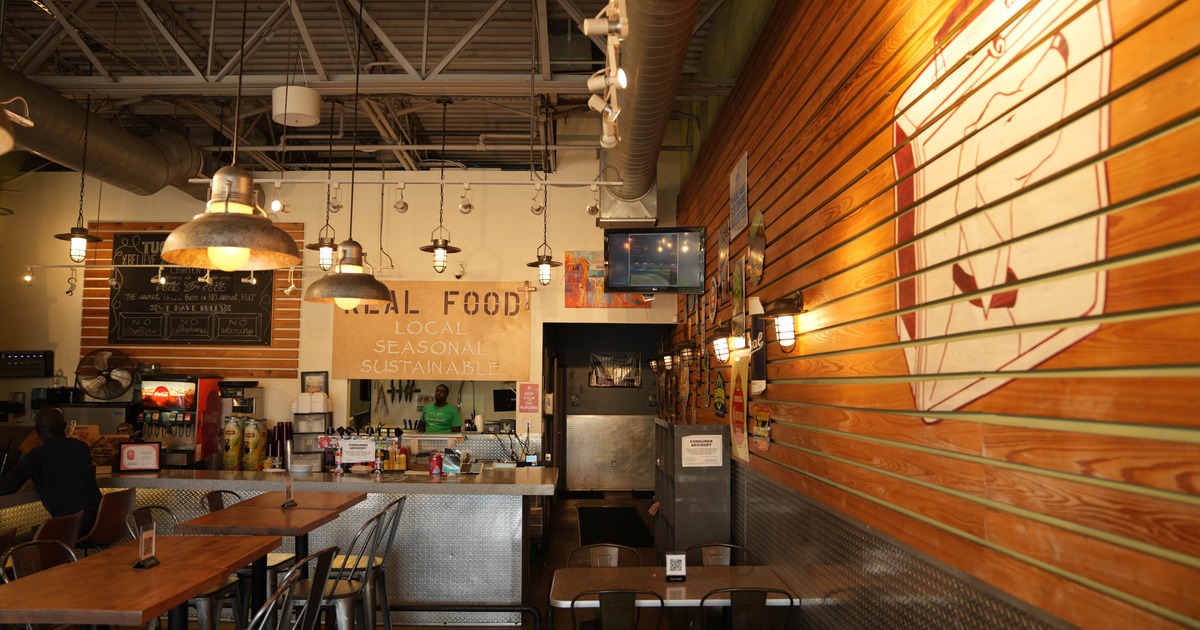 Interior with exposed beams, pendant lights and a counter with 