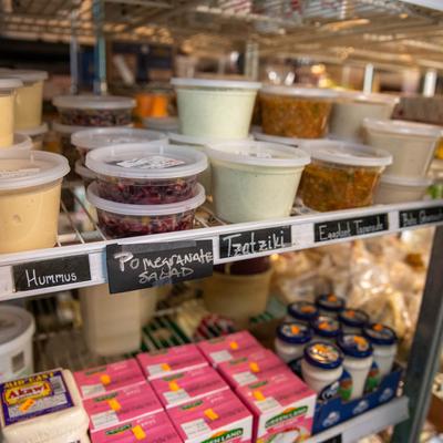 A variety of Mediterranean products neatly arranged on shelves in a grocery store.