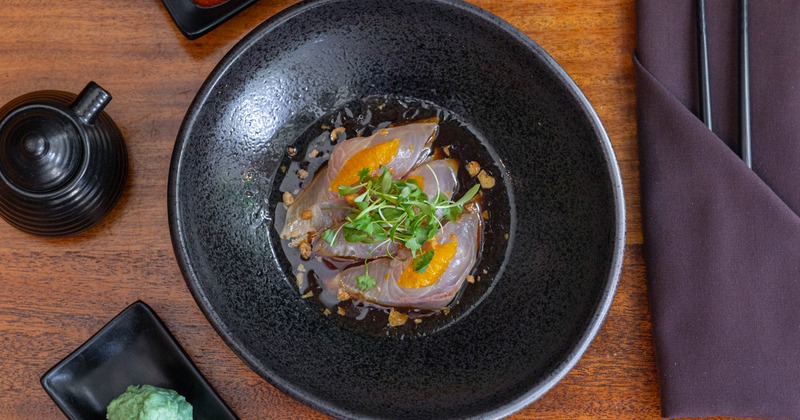 Amberjack sashimi, with orange, garlic chips, cilantro, and oil