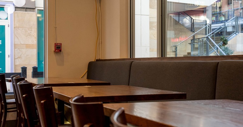 Interior, bench, tables and chairs in seating area