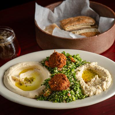 Vegetarian Plate and pita bread on a table.