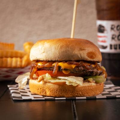 Cheeseburger with lettuce, tomato, and grilled onions.