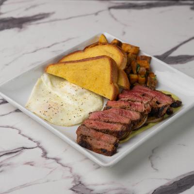 Steak and Eggs with toast and breakfast potatoes.
