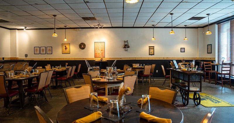 Interior, set dining tables waiting to receive guests