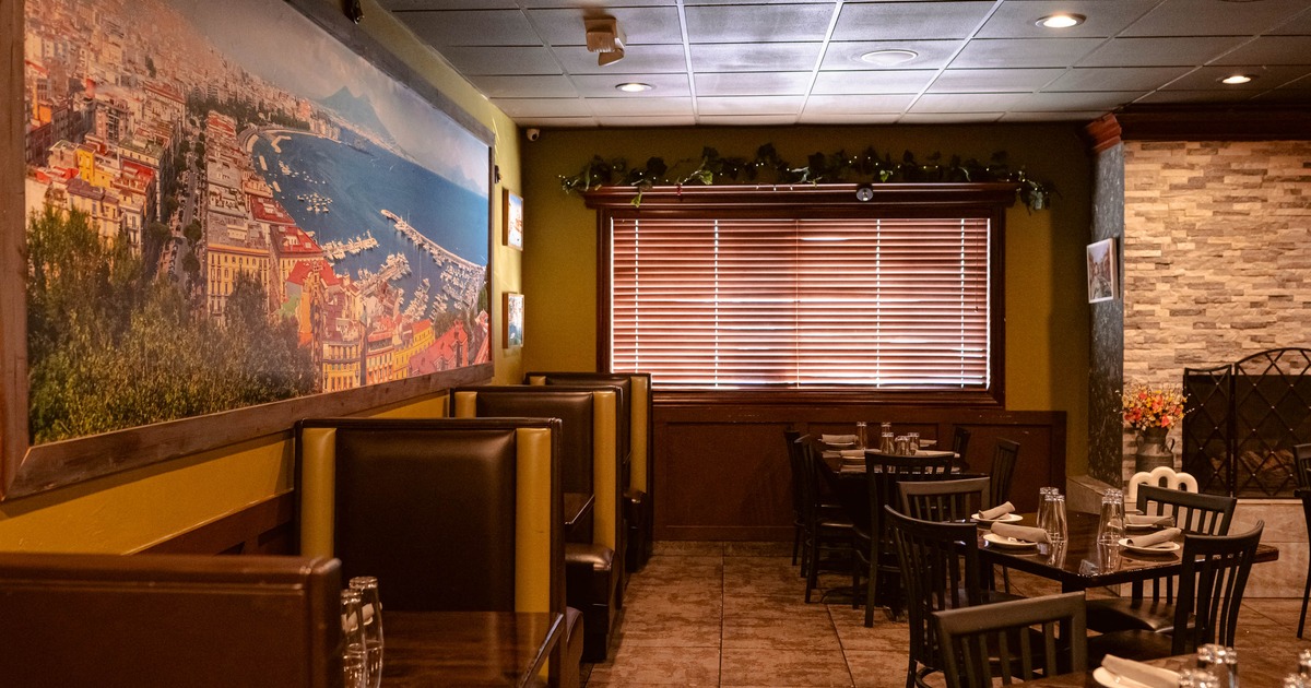 Interior, dining area, seating booths for two on the left, regular tables on the right