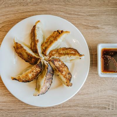 Pork dumplings with dipping sauce, top view.