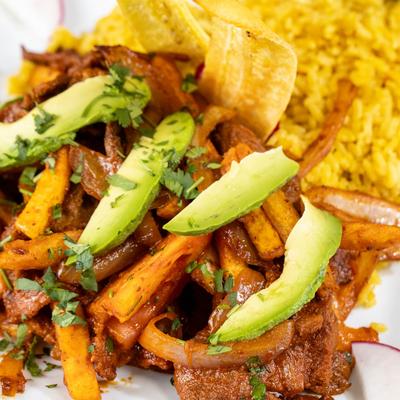 Sautéed steak with fries and rice.