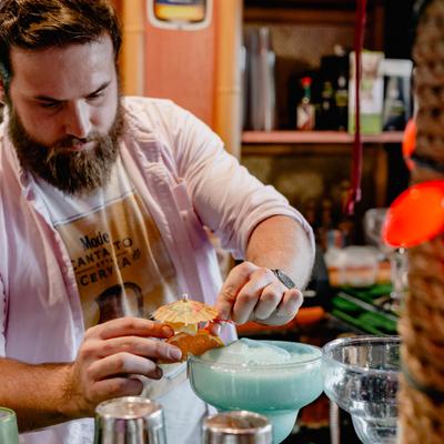 Bartender garnishing drinks