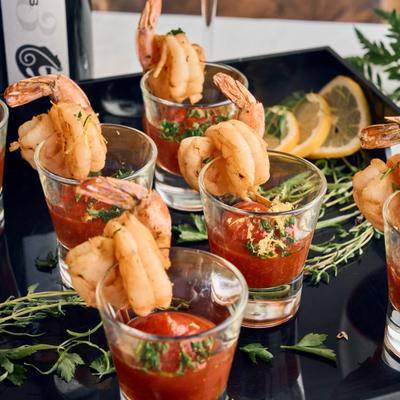 shrimp cocktail shooter with spicy cockail sauce.