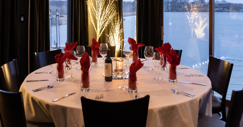 Interior, a round table with tableware and glasses, ready for guests