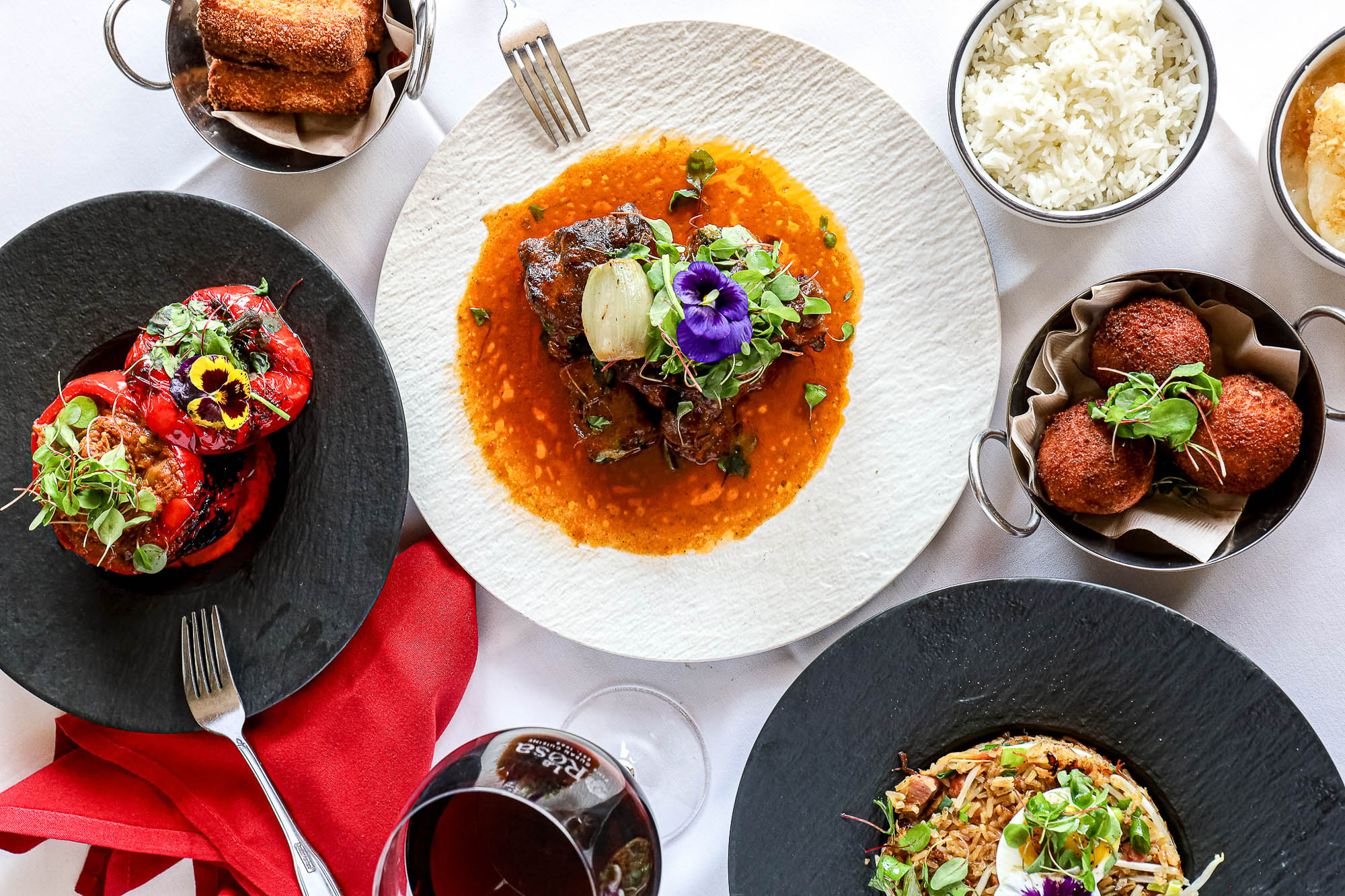 Braised oxtail served with rice, and red wine, top view