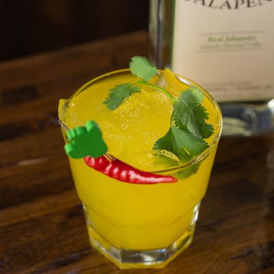 El Diablo cocktail, topped with cilantro, garnished with a red chili pepper