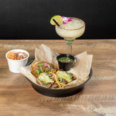 Mexican street tacos with margarita, rice, and beans.