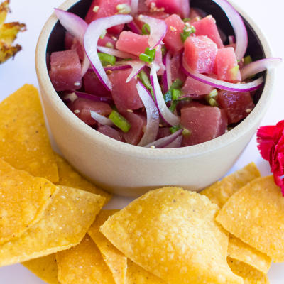 Chips and a bowl of sliced vegetables.