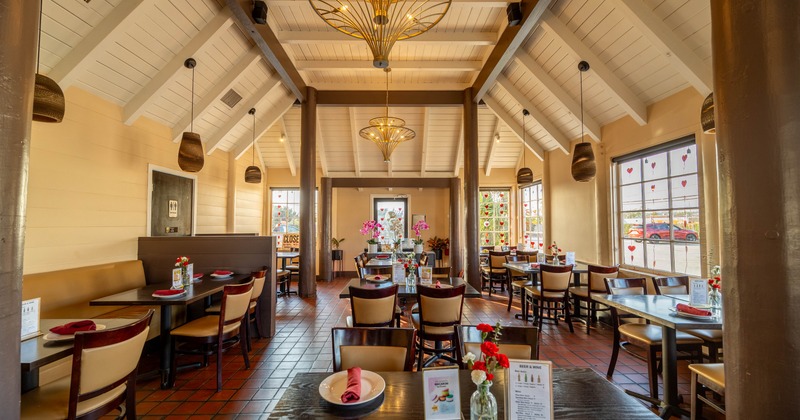 Interior, elegant dining space with vitrage glass windows, chandeliers
