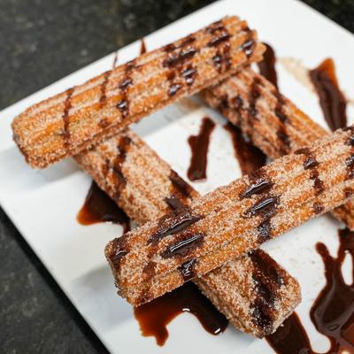Churros with chocolate drizzle.