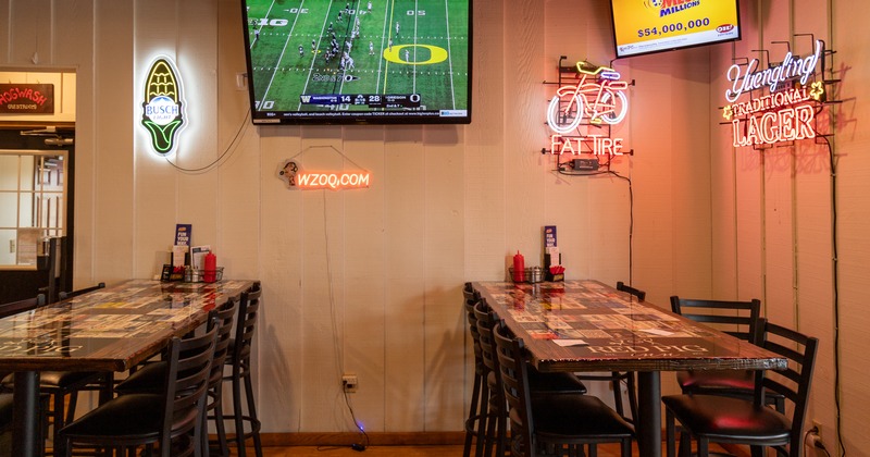 Diner tables, tv screen above