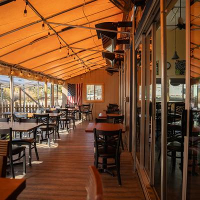 The covered patio, tables and chairs.