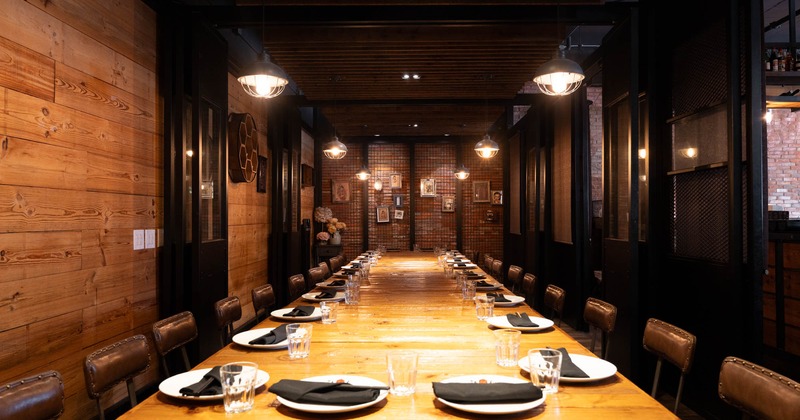 Interior, private dining area, long table wooden top table for twenty, wood coated walls