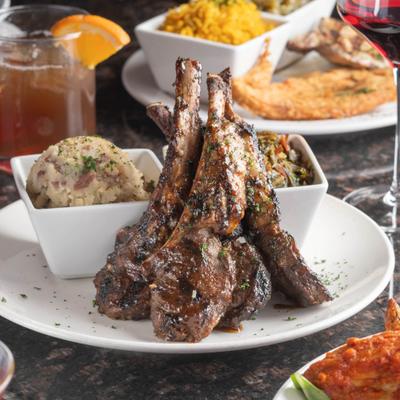 Lamb chops served with mashed potatoes and vegetables.